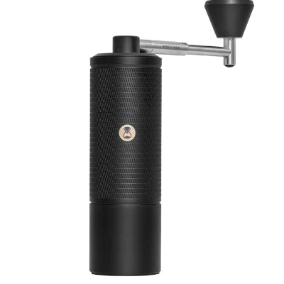 Black manual coffee grinder on a white background