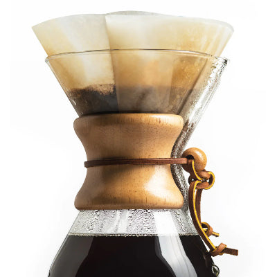Glass coffee maker with wooden collar on a white background