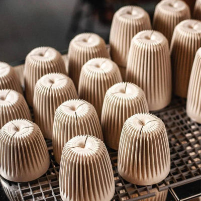 Row of coffee mugs on a metal rack