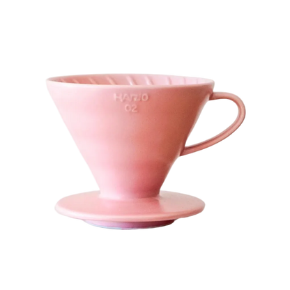 Pink ceramic coffee filter on a white background