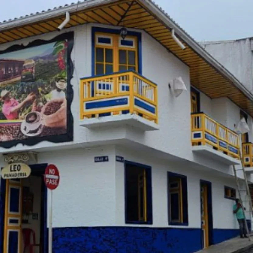 Colorful building with a mural and balcony in a town setting