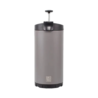 A stainless steel travel coffee maker with a dark gray lid and base, featuring a visible BRÜKER logo near the bottom, set against a plain white background.