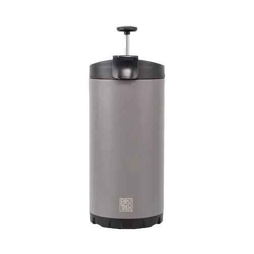 A stainless steel travel coffee maker with a dark gray lid and base, featuring a visible BRÜKER logo near the bottom, set against a plain white background.