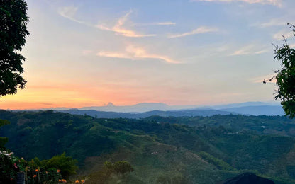 Hillside landscape with a sunset sky