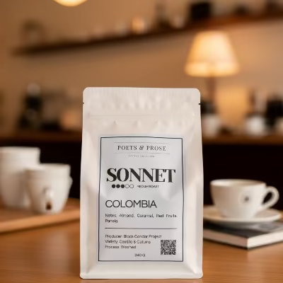 Coffee bag labeled 'Sonnet' from Poets & Prose on a blurred coffee shop background