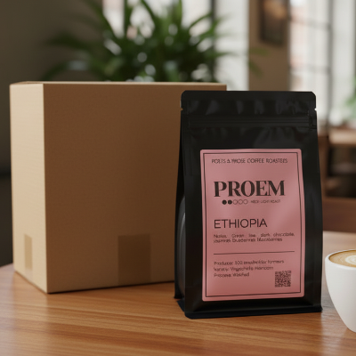 PROEM Ethiopia coffee bag on a table with a cup of coffee and a cardboard box in the background.