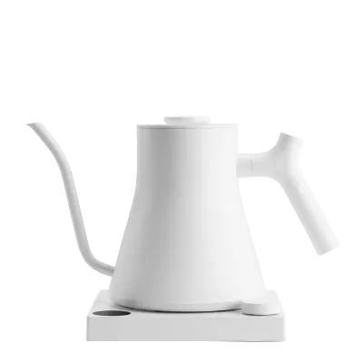 A minimalist white electric kettle with a long spout and integrated handle, resting on a matching white charging base against a solid white background.