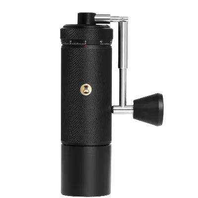 Black manual coffee grinder on a white background