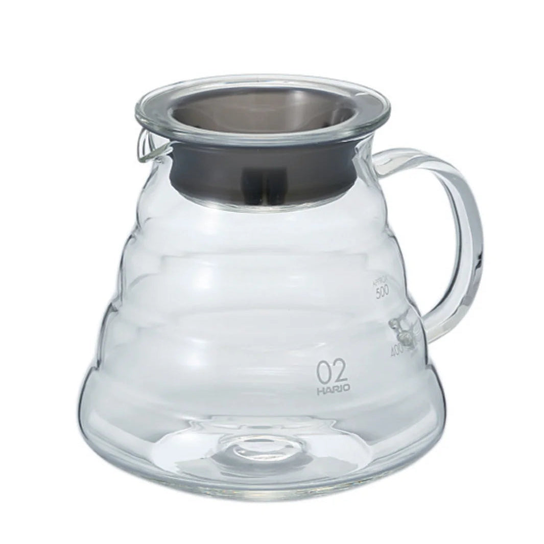Clear glass coffee server with metal lid on a white background