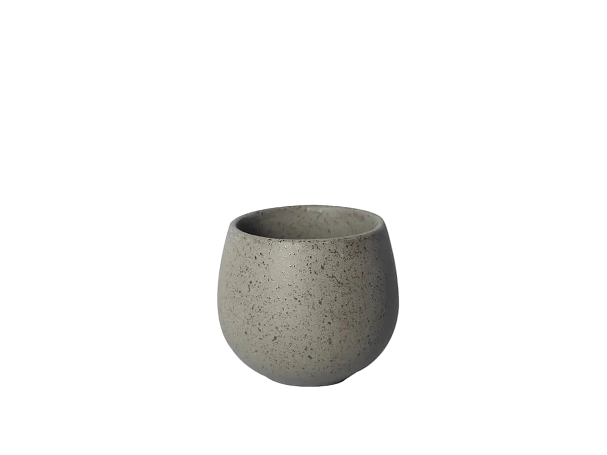 A small, round, speckled gray ceramic cup or planter with a matte finish, centered on a solid white background.