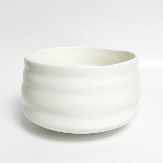 White ceramic matcha bowl on a light gray background