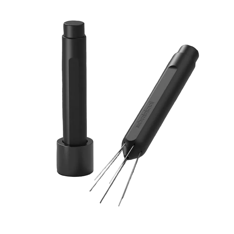 A black cylindrical cleaning tool with four thin metal prongs, shown alongside its matching black charging base on a dark gray background.